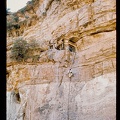 08+Secure+dwelling+cut+in+cliff,+man+in+place,+another+climbing+up+with+a+rope